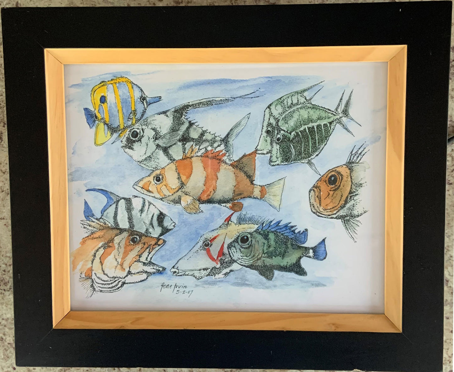School of Fish framed Giclée print by Gene Irvin, 2007 — whimsical ink stippling and watercolor illustration of seven colorful tropical fish species swimming together including a yellow-striped Butterflyfish, orange-banded fish, Pufferfish, striped fish, and blue-finned fish against a soft blue watercolor ocean wash, black outer frame with natural wood inner frame, 10x8 inch print, 12.5x10.5 inches overall, ready to hang