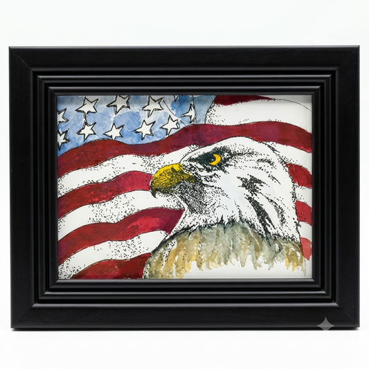 Bald Eagle and American Flag framed art print by Gene Irvin — bold pen, ink, and watercolor portrait of a Bald Eagle head with yellow beak and golden eye in the foreground against a waving American flag with red stripes and white stars, black ridged wood frame, 5x7 print, 9.125x7 inches overall, ready to hang