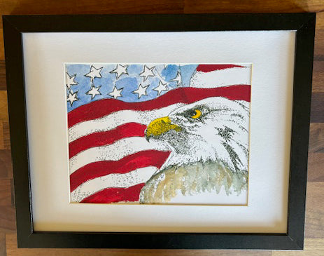 Bald Eagle and American Flag framed art print by Gene Irvin — pen, ink stippling and watercolor portrait of a Bald Eagle with yellow beak and piercing eye set against a waving American flag with red stripes and white stars, white mat, flat black modern frame, 8x10 print, 15.25x13.25 inches overall, ready to hang