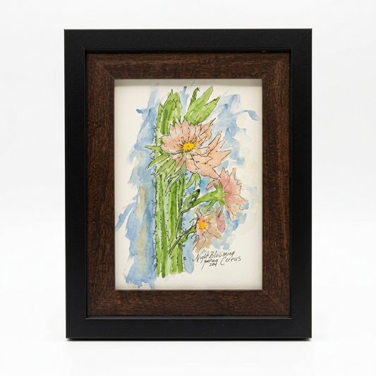 "Night-blooming Cereus framed art print by Gene Irvin, 2021 — loose watercolor and ink illustration of soft pink cereus blooms with yellow centers on tall green spiny stems against a blue watercolor wash, dark walnut wood frame, 5x7 print, 7.625x9.625 inches overall, ready to hang"