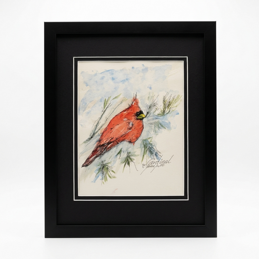 Original Northern Cardinal watercolor and ink illustration by Gene Irvin, signed 2000 — a vivid red male cardinal with black face mask and orange beak perched among pine boughs against a soft blue winter wash, double-matted in black in a flat black wood frame, 12.25×15.25 inches, ready to hang